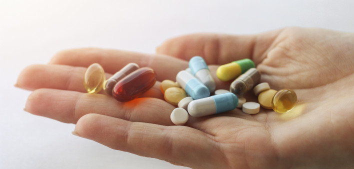 hand holding vitimins and supplements