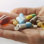 hand holding vitimins and supplements