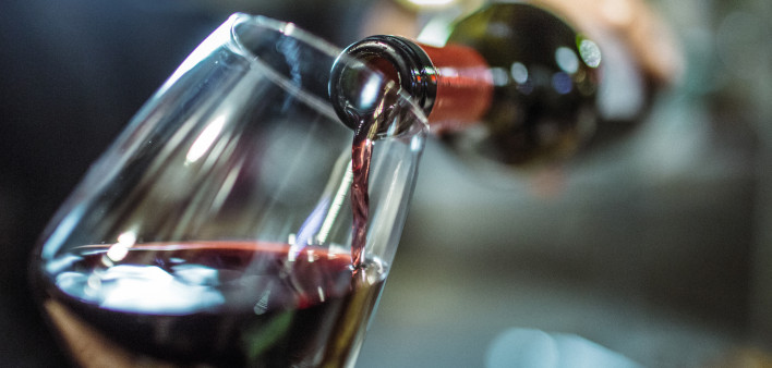 red wine pouring into glass
