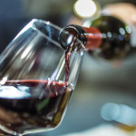 red wine pouring into glass