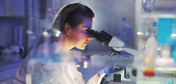 woman researcher in lab microscope