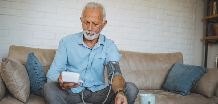 Senior man measuring his blood pressure