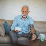 Senior man measuring his blood pressure