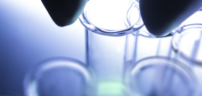 fingers holding a test tube