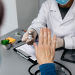 Female patient refusing the coronavirus vaccine offered by her doctor