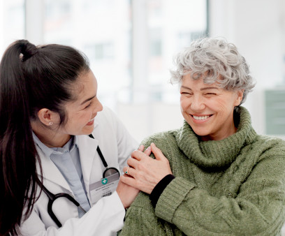 Happy, care and face of a doctor with a woman for medical trust, healthcare