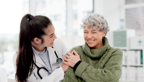 Happy, care and face of a doctor with a woman for medical trust, healthcare