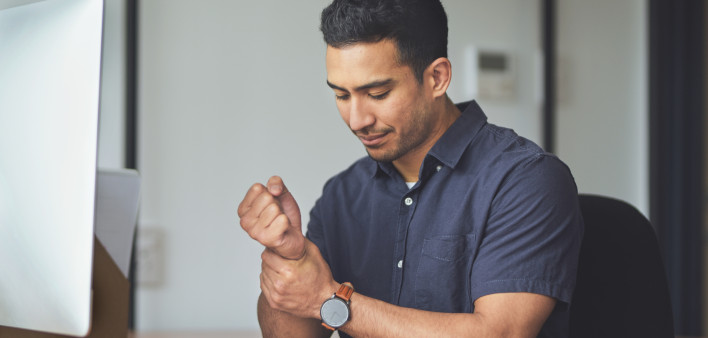 man holding wrist in pain
