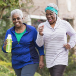 Three senior black women exercising together
