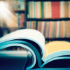 an open book in a libray books on shelf