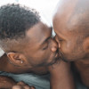 two black gay men kiss