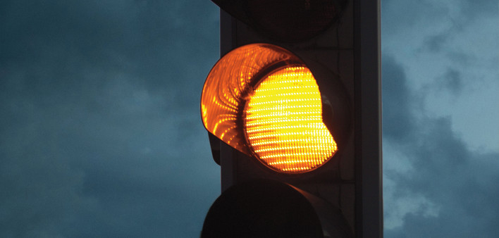 yellow caution light at dusk
