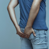 man holds his butt