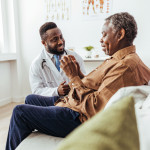 Black doctor and black patient consultation