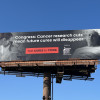 Billboards in Tennessee and Alabama urge U.S. Congress members not to cut cancer research funding.
