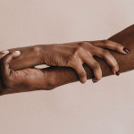 two hands holding each other black