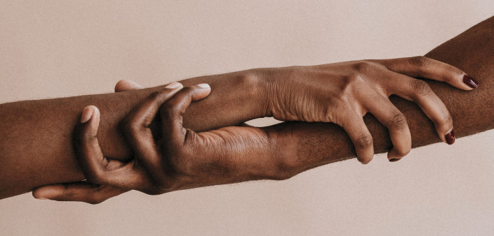 two hands holding each other black