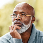 senior man outdoors thinking