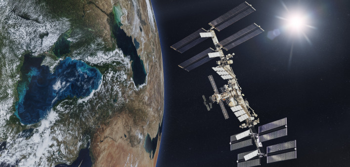 International Space Station on low-orbit of Earth with rising Sun. Elements of this image furnished by NASA.