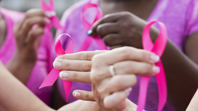 Multi-ethnic women with breast cancer awareness ribbons
