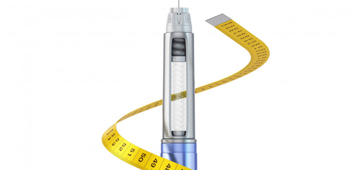 weight loss drug and measuring tape