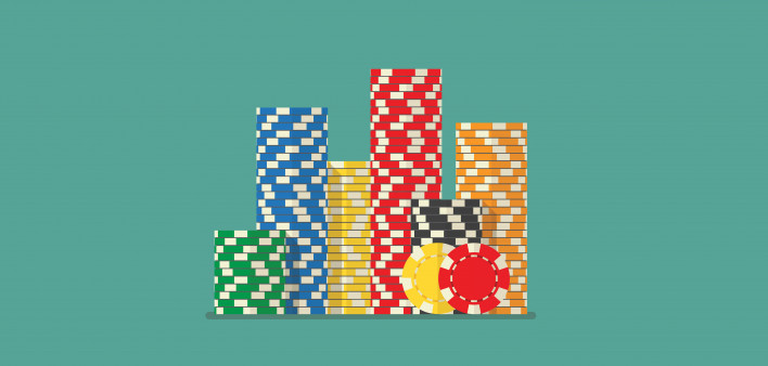 stack of poker chips on green backround