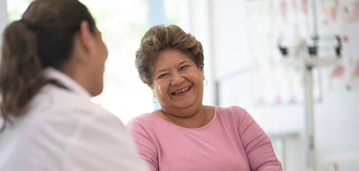 Older Woman talking with the Doctor laughing