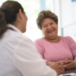 Older Woman talking with the Doctor laughing