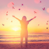 woman arms stretched out sunrise birds beach