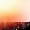 crowd of people from behind looking toward light
