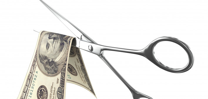 scissors cutting 100 bill