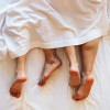couple under the covers with feet showing