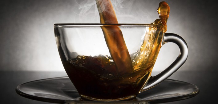 coffee pouring into a clear glass cup