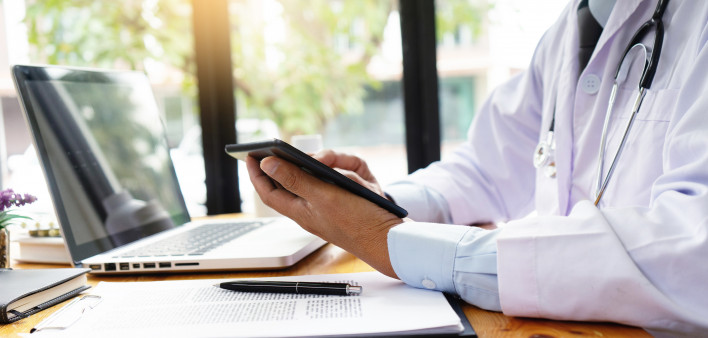 professional doctor use computer and tablet