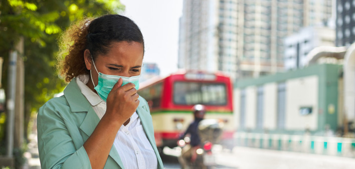 African American women wearing masks face dust Smoke problems on the road in the capital. stock photo City, Coughing, Pollution, Adult, Adults Only