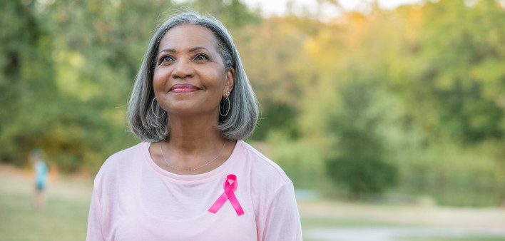 Beautiful senior woman smiles while walking for breast cancer awareness
