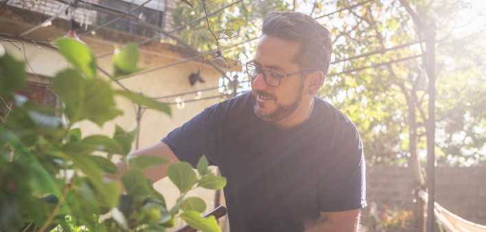 A healthy Latino man living with HIV in the garden