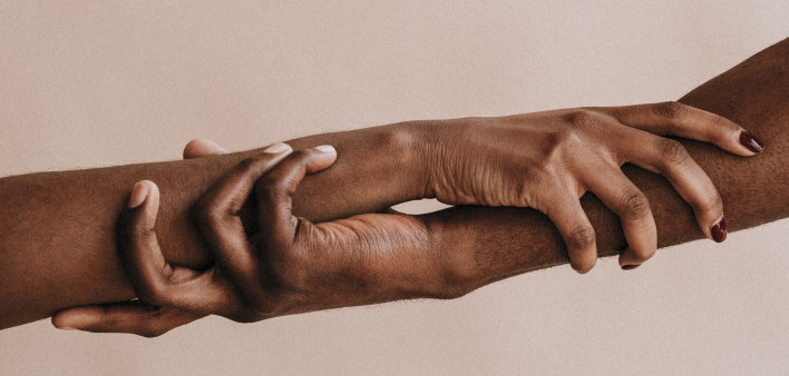 two hands holding each other black