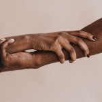 two hands holding each other black