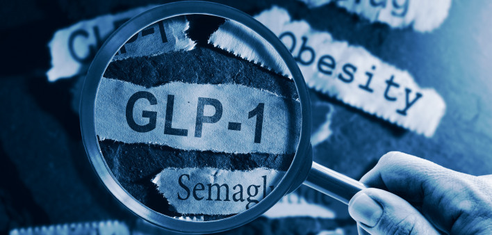 GLP-1 related drugs newspaper headlines with hand and magnifying glass stock photo Glucagon-like peptide-1, Medicine, Dieting, Semaglutide, Obesity