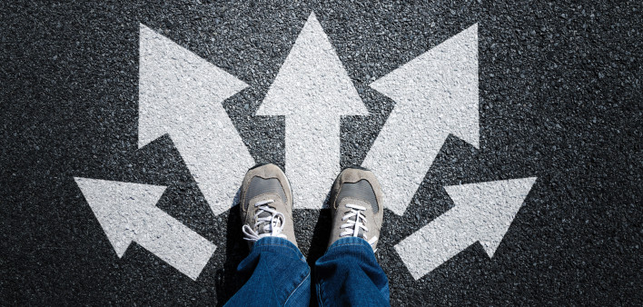 feet with arrows on pavement