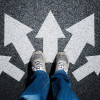feet with arrows on pavement