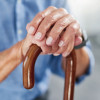 old man's hands on a cane