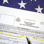 Application form for Immigrant visa and registration with American flag in the backdrop. USA immigrant visa application process