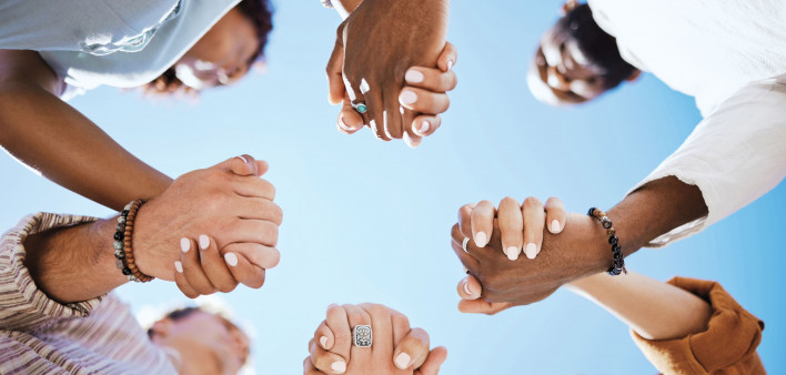 group of people holding hand to form a circle support