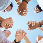 group of people holding hand to form a circle support