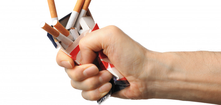 Hand crushing box of cigarettes