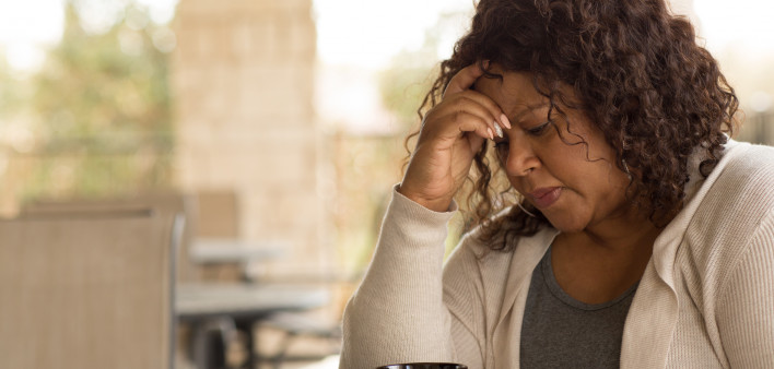 African American middle age woman looking sad.