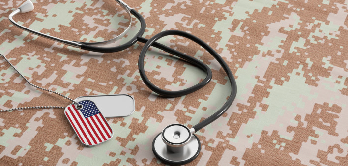 USA military doctor. American flag identification tags and stethoscope on digital camouflage fabric.