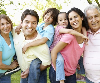 A multi-generational latin family having fun outdoors
